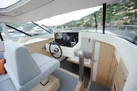 Luxurious interior of 2018 Steeler 52s yacht with modern helm and panoramic windows.
