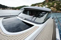 Steeler 52s yacht (2018) on water, showcasing sleek design and spacious deck.