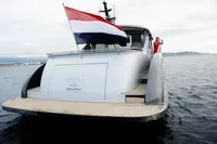Steeler 52s yacht from 2018 with flag, cruising on open water.