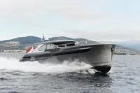 Luxurious 2018 Steeler 52s yacht cruising on open water with scenic mountain backdrop.