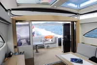 Luxurious interior of 2018 Steeler 52s yacht with ocean view and modern furnishings.