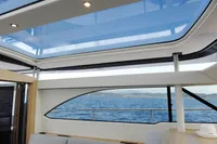 Interior view of 2018 Steeler 52s yacht with panoramic windows and ocean backdrop.