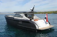 2018 Steeler 52s yacht on calm water, featuring sleek design and flag at stern.