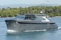 2018 Steeler 52s yacht cruising on a scenic waterway with lush greenery.