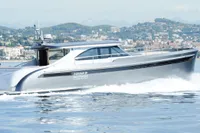 Steeler 52s yacht cruising on water, 2018 model, with scenic coastal backdrop.