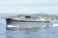 2018 Steeler 52s yacht cruising on calm waters with scenic coastal backdrop.