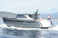 2018 Steeler 52s yacht cruising on open water with scenic coastal backdrop.