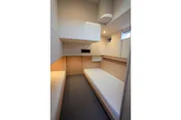 Interior cabin of 2018 Steeler 52s yacht with minimalist design and twin beds.