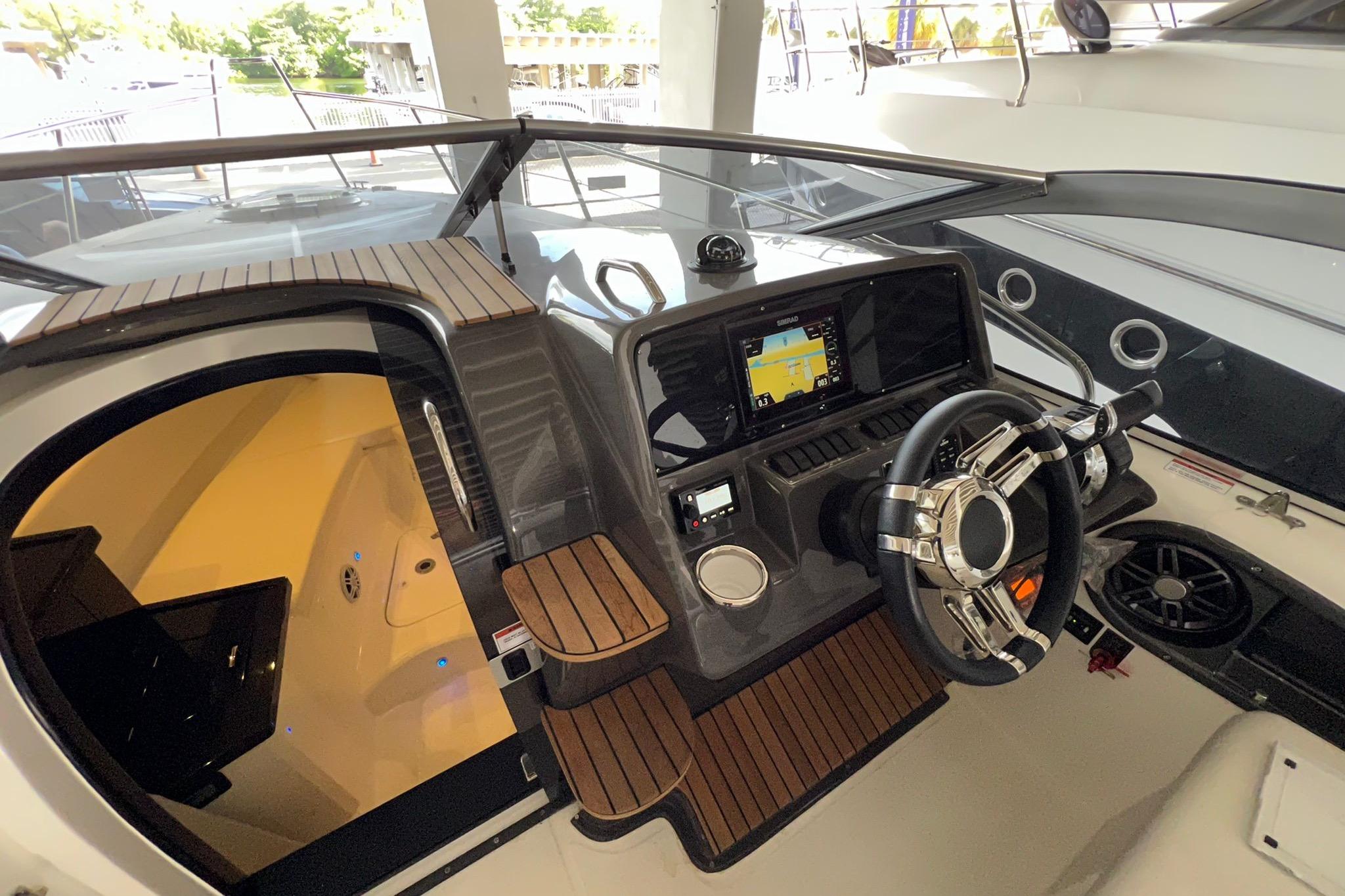 2023 Schaefer 303 Sport boat cockpit with modern steering and navigation system.