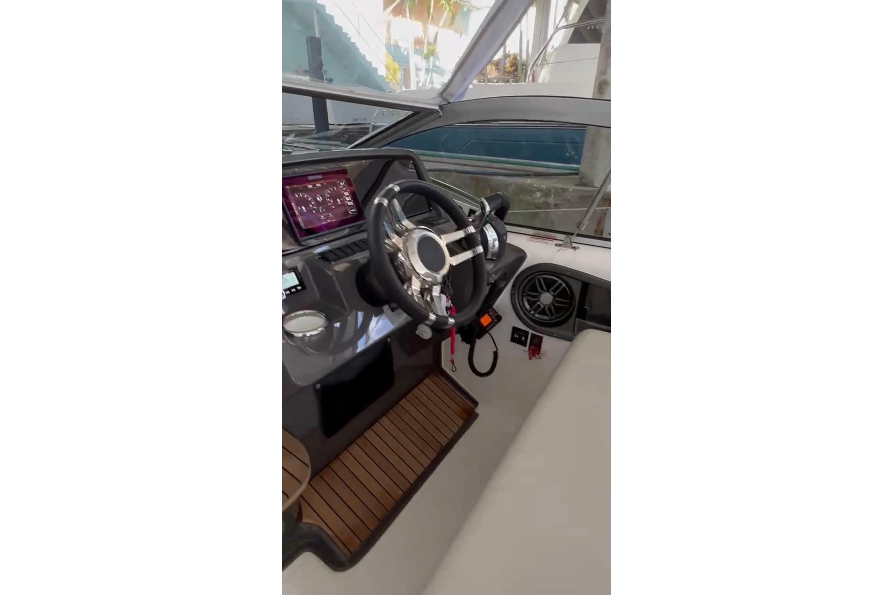 2023 Schaefer 303 Sport boat interior with modern steering and dashboard.