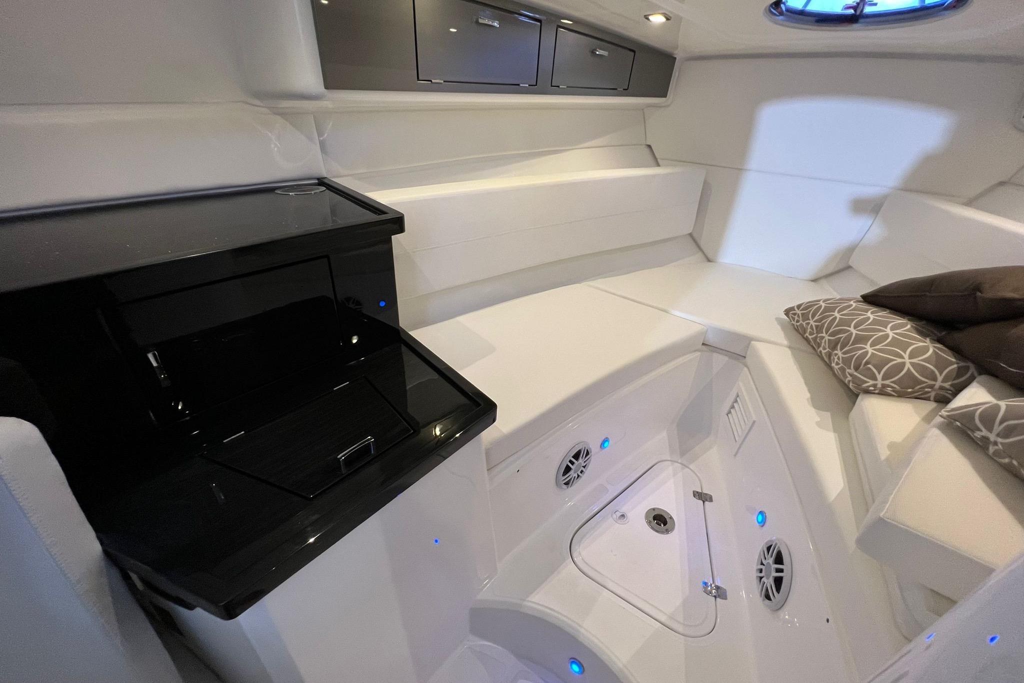 Luxurious interior of 2023 Schaefer 303 Sport boat with modern amenities and elegant seating.
