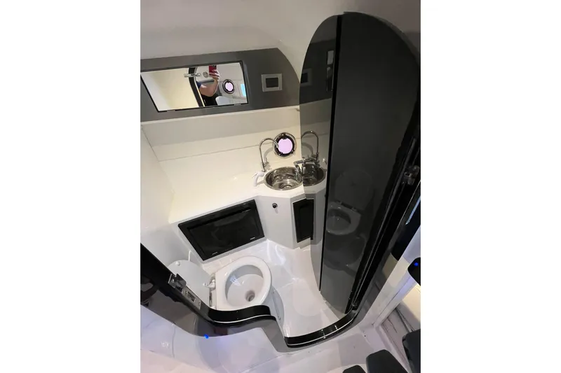  Yacht Photos Pics 2023 Schaefer 303 Sport boat bathroom with modern fixtures and compact design.