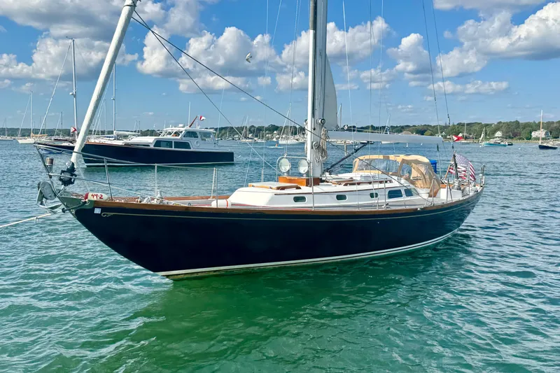 Fandango Yacht Photos Pics 1982 Hinckley Bermuda 40 MK III sailboat on calm water under blue sky.
