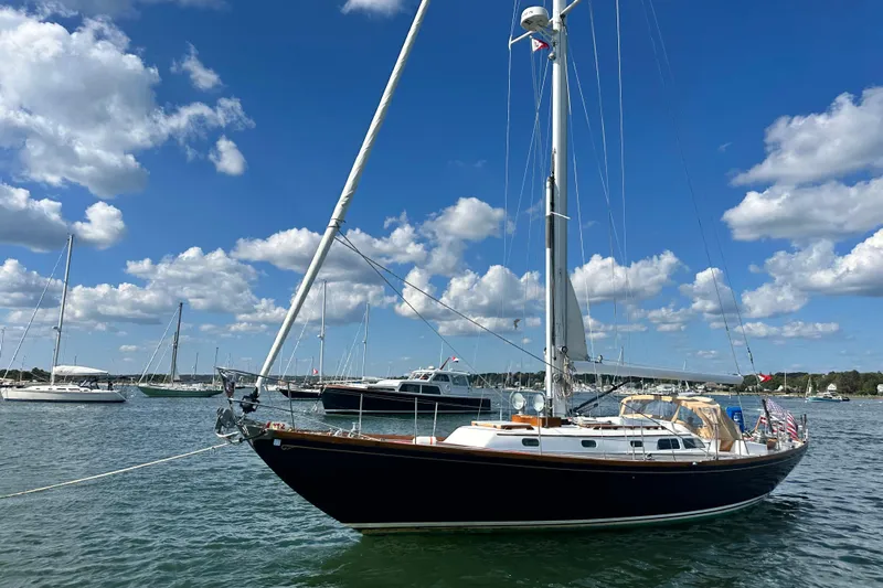 Fandango Yacht Photos Pics 1982 Hinckley Bermuda 40 MK III sailboat on calm water under a blue sky.