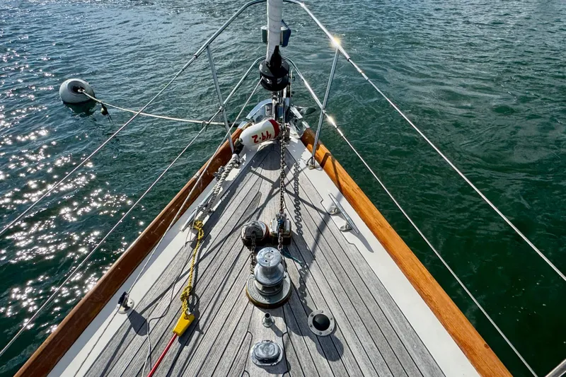 Fandango Yacht Photos Pics Bow of 1982 Hinckley Bermuda 40 MK III sailboat on sparkling water.