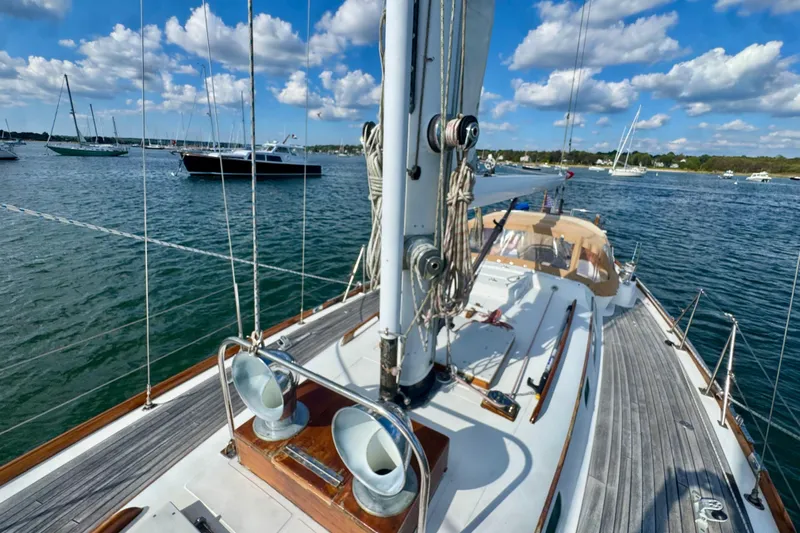Fandango Yacht Photos Pics Hinckley Bermuda 40 MK III sailboat on water, 1982 model, with clear skies and other boats nearby.