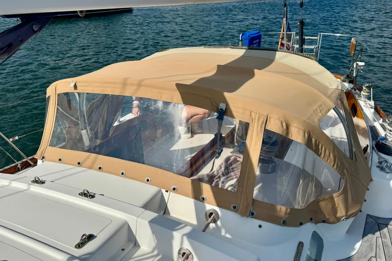 Fandango Yacht Photos Pics Hinckley Bermuda 40 MK III sailboat with tan canopy, docked on calm water, 1982 model.