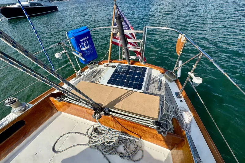 Fandango Yacht Photos Pics Hinckley Bermuda 40 MK III sailboat deck with solar panel, ropes, and American flag, 1982 model.