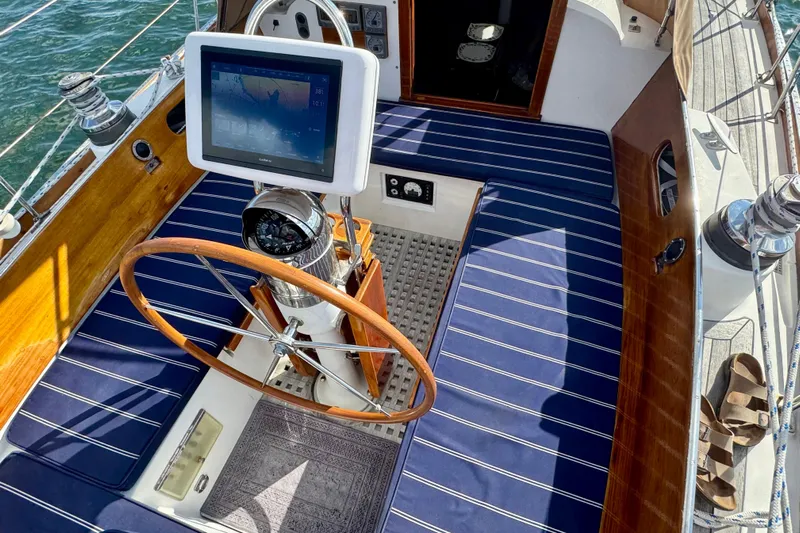 Fandango Yacht Photos Pics Cockpit of 1982 Hinckley Bermuda 40 MK III sailboat with wooden wheel and navigation display.
