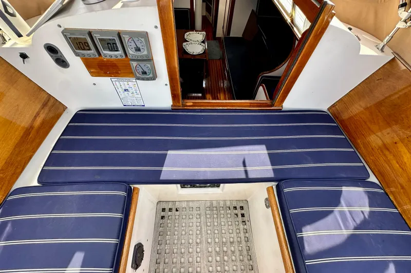 Fandango Yacht Photos Pics 1982 Hinckley Bermuda 40 MK III cockpit with blue striped cushions and navigation instruments.