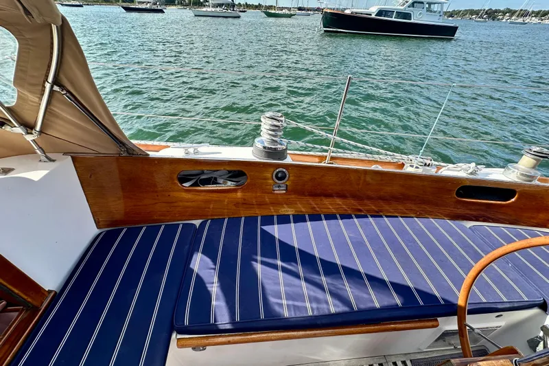 Fandango Yacht Photos Pics 1982 Hinckley Bermuda 40 MK III sailboat cockpit with striped cushions and wooden details.