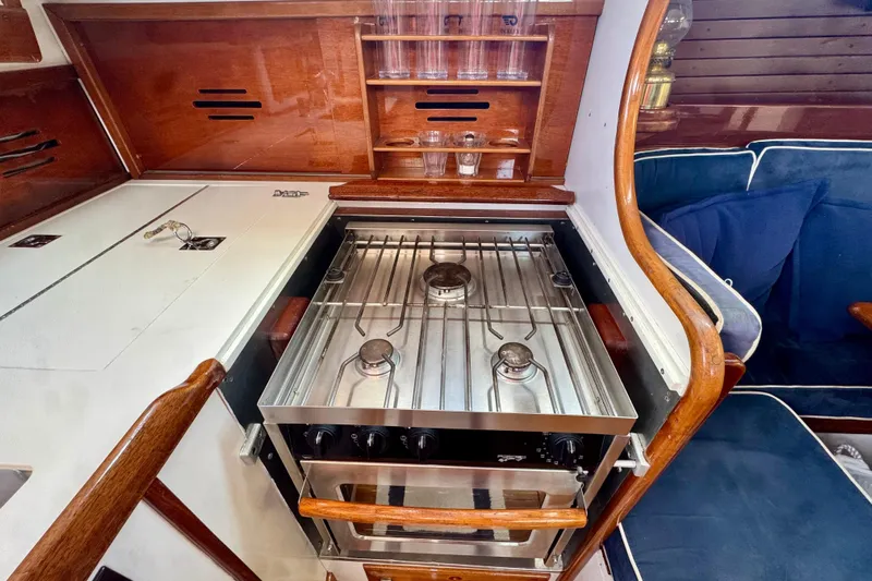 Fandango Yacht Photos Pics Galley kitchen in 1982 Hinckley Bermuda 40 MK III yacht with stove and wooden cabinetry.