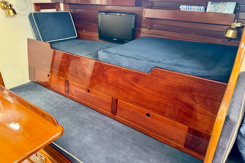 Fandango Yacht Photos Pics Interior of 1982 Hinckley Bermuda 40 MK III with wooden finish and blue cushions.