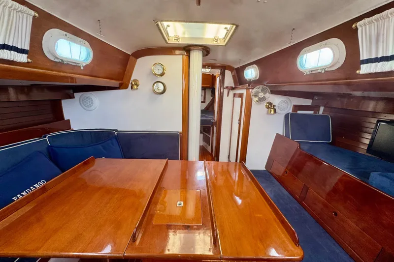 Fandango Yacht Photos Pics Interior of 1982 Hinckley Bermuda 40 MK III sailboat with polished wood and blue seating.
