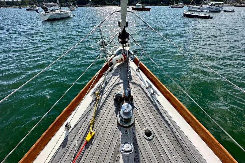 Fandango Yacht Photos Pics Hinckley Bermuda 40 MK III sailboat deck, 1982 model, on calm waters with other boats nearby.