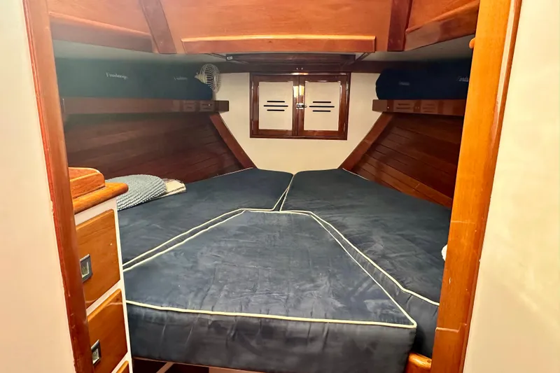 Fandango Yacht Photos Pics Interior cabin of 1982 Hinckley Bermuda 40 MK III with wooden finish and blue bedding.