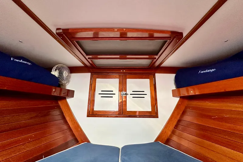 Fandango Yacht Photos Pics Interior cabin of 1982 Hinckley Bermuda 40 MK III with wooden finish and blue bedding.