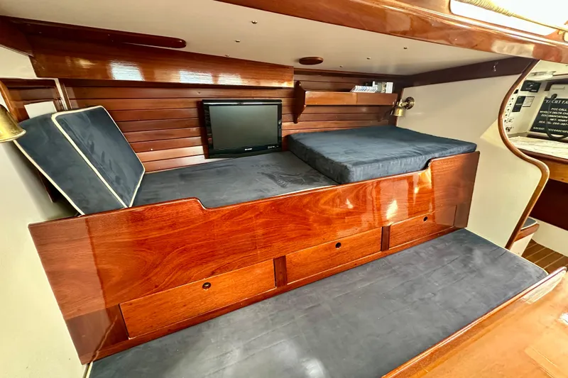 Fandango Yacht Photos Pics Interior of 1982 Hinckley Bermuda 40 MK III with wooden finish and blue cushions.