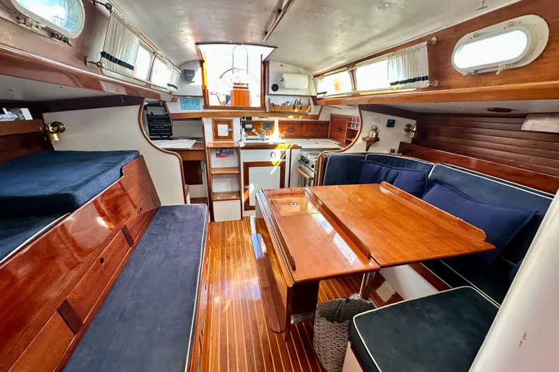 Fandango Yacht Photos Pics Interior of 1982 Hinckley Bermuda 40 MK III sailboat with wooden furnishings and cozy seating.