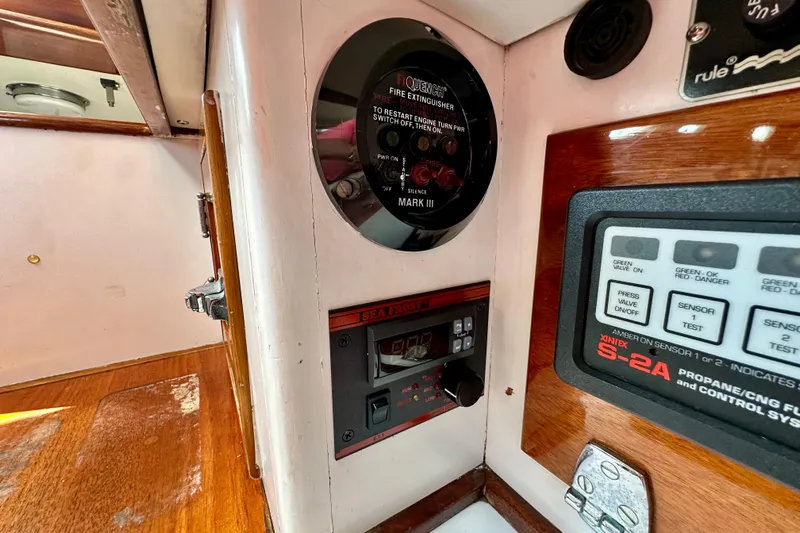 Fandango Yacht Photos Pics Hinckley Bermuda 40 MK III 1982 yacht interior with control panels and fire extinguisher.