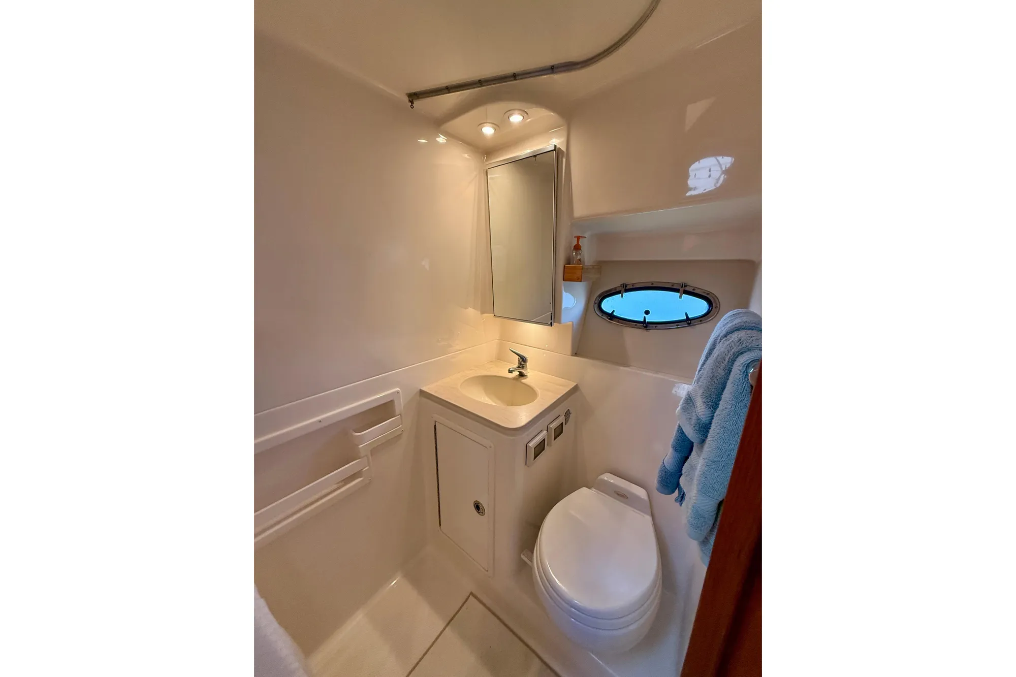 2005 Tiara 3600 Open yacht bathroom with sink, toilet, and porthole window.