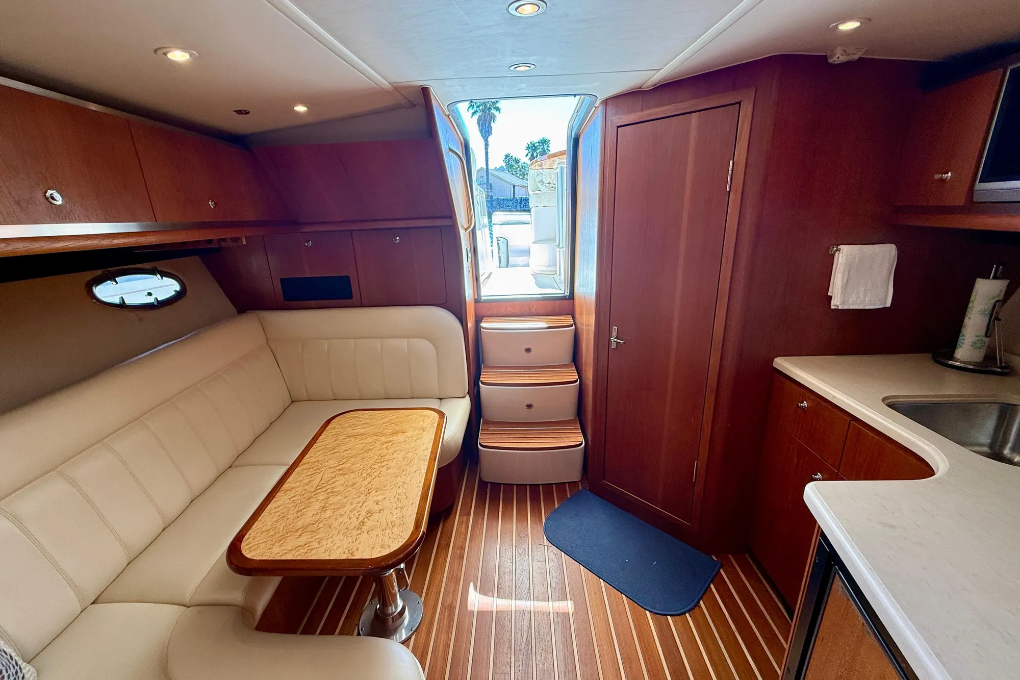 2005 Tiara 3600 Open yacht interior with wood finish and cozy seating area.