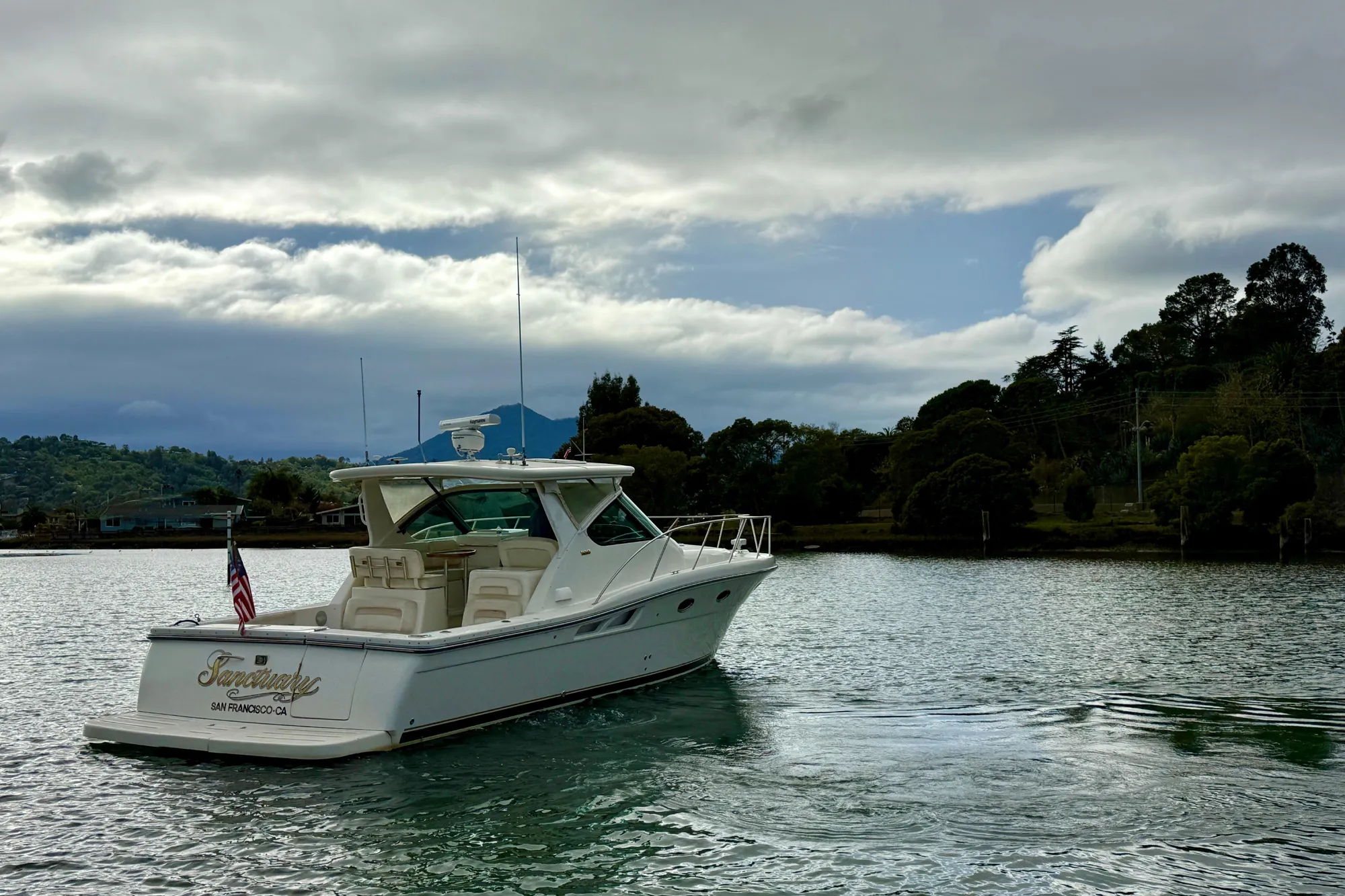 2005 Tiara 3600 Open yacht on calm water under cloudy sky.