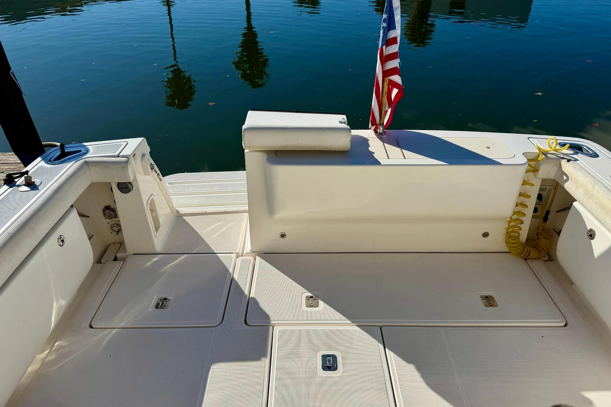 2005 Tiara Yachts 3600 Open boat deck with American flag, docked by calm water.