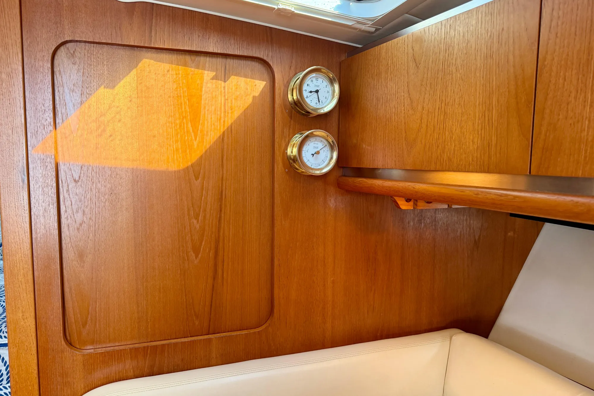 Interior of 2005 Tiara Yachts 3600 Open with wooden paneling and brass instruments.