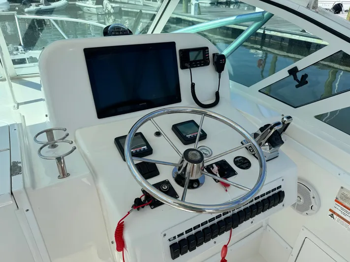 Destiny Yacht Photos Pics 2012 Albemarle 280 XF Express helm with steering wheel and navigation controls.