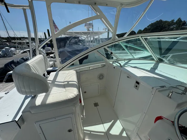 Destiny Yacht Photos Pics 2012 Albemarle 280 XF Express boat interior with white seating and helm station.