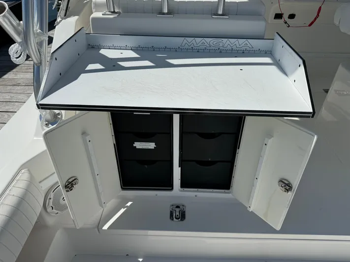 Destiny Yacht Photos Pics Albemarle 280 XF Express 2012 fishing station with storage compartments and cutting board.