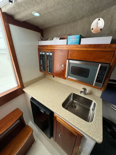 Destiny Yacht Photos Pics 2012 Albemarle 280 XF Express boat interior with kitchenette, microwave, sink, and storage cabinets.