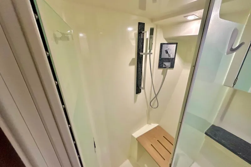 Favorite Mistake Yacht Photos Pics Shower area in 2013 Monterey 400 Sport Yacht with modern fixtures and wooden seat.