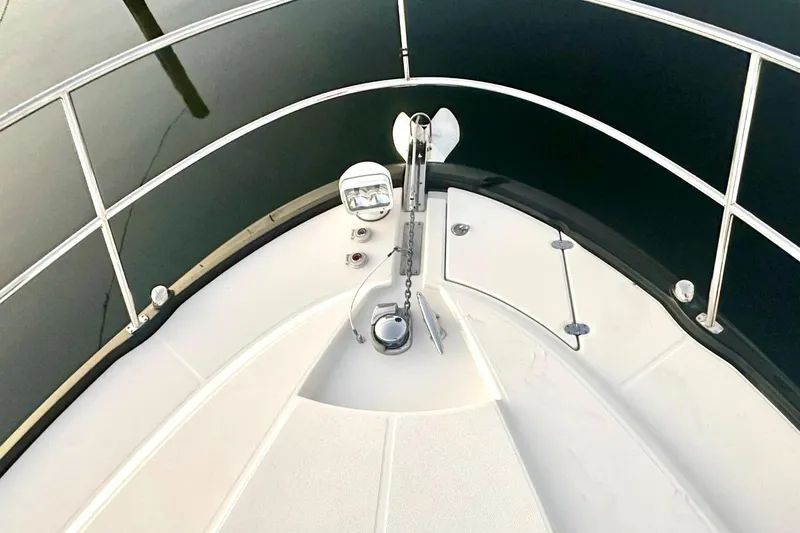 Favorite Mistake Yacht Photos Pics 2013 Monterey 400 Sport Yacht bow with anchor and railing, docked on calm water.