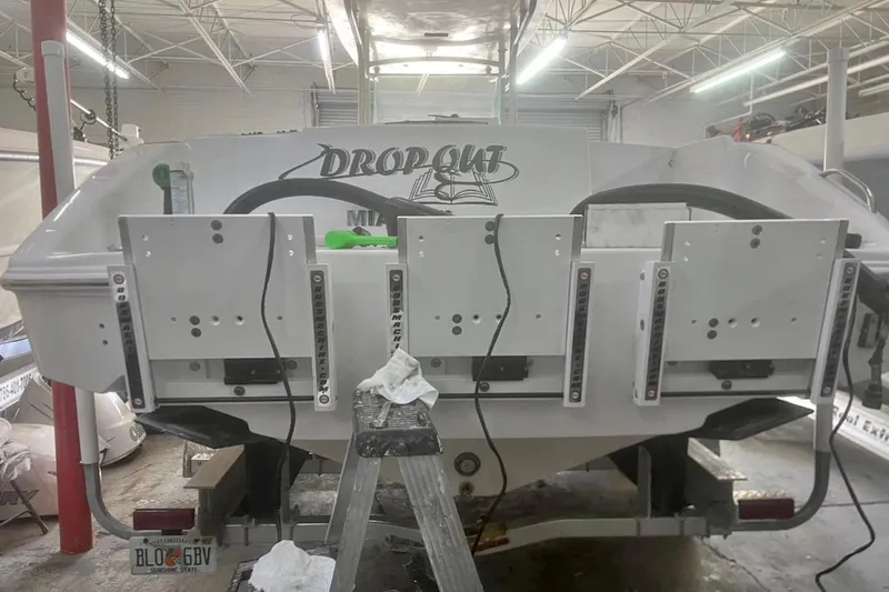  Yacht Photos Pics 2001 Donzi 32 VS boat in a garage, showing the rear with mounting brackets.