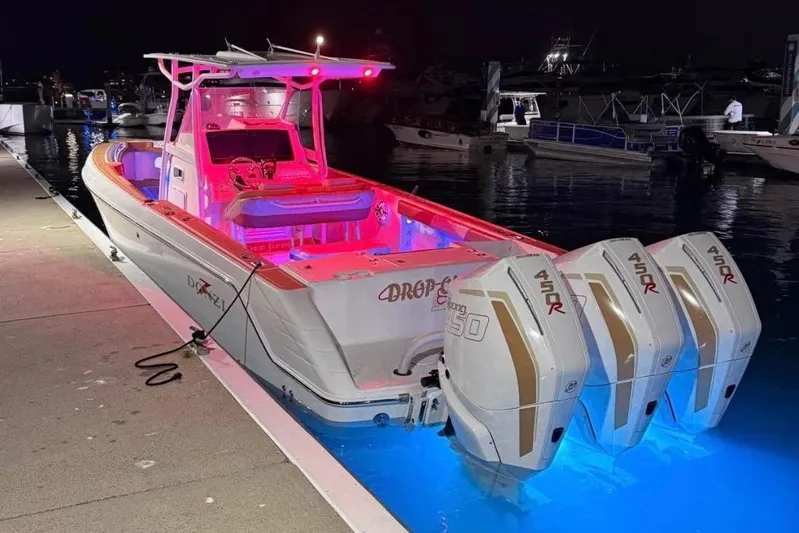  Yacht Photos Pics 2001 Donzi 32 VS boat docked at night, illuminated with vibrant pink and blue lights.