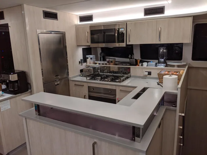La Grande Bellezza Yacht Photos Pics Modern kitchen interior on a 2019 Leopard 58 yacht, featuring sleek appliances and ample counter space.