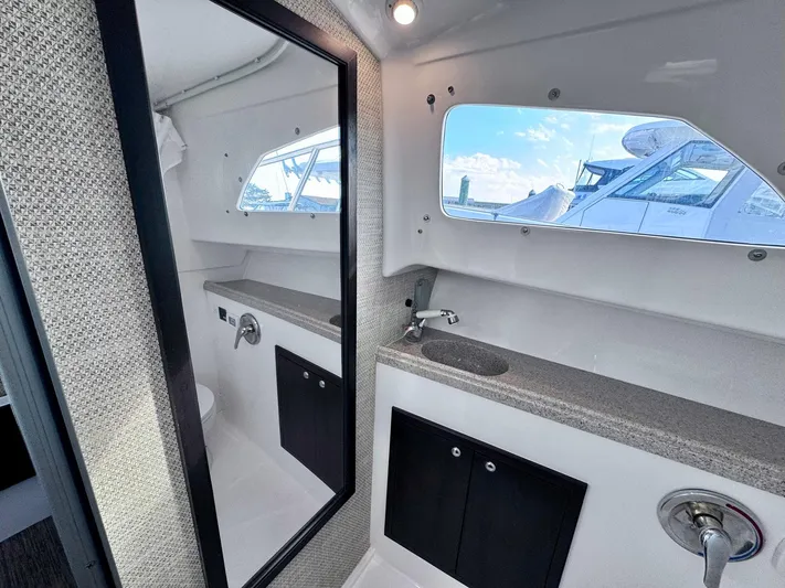 Seanior Moment Yacht Photos Pics Interior of 2022 Stamas 370 Aegean yacht bathroom with mirror and window view.