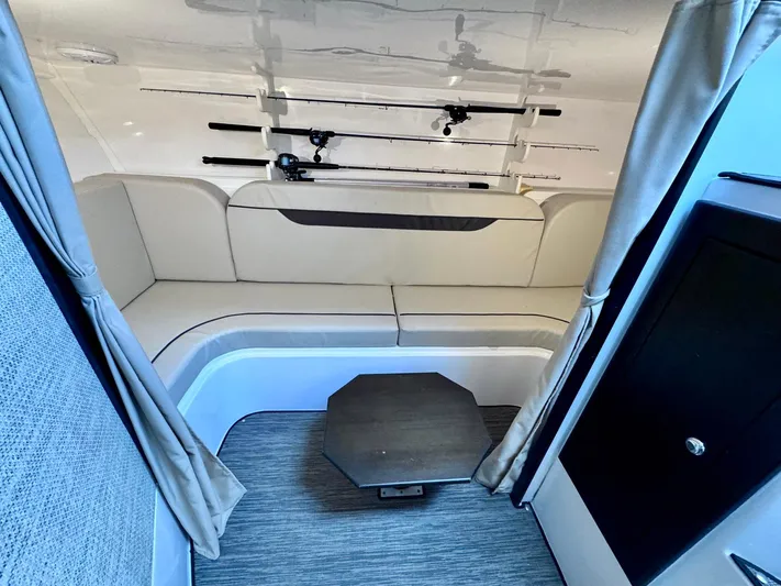 Seanior Moment Yacht Photos Pics 2022 Stamas 370 Aegean interior with seating, table, and fishing rods.